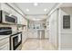 Bright kitchen with stainless steel appliances, white cabinets, and a window overlooking the backyard at 4222 Hartwood Ln # 1202, Tampa, FL 33618