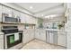 Bright kitchen with stainless steel appliances, white cabinets, and a window overlooking the backyard at 4222 Hartwood Ln # 1202, Tampa, FL 33618