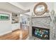 Elegant living room with modern fireplace, built-in bar area, and hardwood floors for sophisticated entertaining at 4222 Hartwood Ln # 1202, Tampa, FL 33618