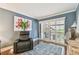 Comfortable living room featuring a plush leather recliner, hardwood floors, and sliding doors to the outside at 4222 Hartwood Ln # 1202, Tampa, FL 33618