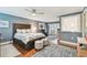 Spacious main bedroom features a large bed, hardwood floors, ceiling fan, and plenty of natural light at 4222 Hartwood Ln # 1202, Tampa, FL 33618