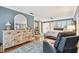 Spacious main bedroom with a large dresser, hardwood floors, and a comfortable sitting chair at 4222 Hartwood Ln # 1202, Tampa, FL 33618