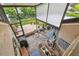 Screened-in patio with brick flooring, a dining table, grill and comfortable seating overlooking the lush backyard at 4222 Hartwood Ln # 1202, Tampa, FL 33618