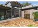 Brick patio with lanai and serene garden offers a relaxing outdoor space at 4222 Hartwood Ln # 1202, Tampa, FL 33618