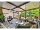 Screened-in patio area with comfortable seating and dining space overlooking the backyard and garden at 4222 Hartwood Ln # 1202, Tampa, FL 33618