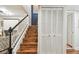 Interior staircase featuring wooden steps, white risers, and dark trim, next to large closet at 4222 Hartwood Ln # 1202, Tampa, FL 33618