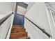 Stairway featuring wood steps, a dark blue accent wall, and white bannisters at 4222 Hartwood Ln # 1202, Tampa, FL 33618