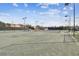 View of well-maintained community tennis courts with professional lighting for evening play at 4222 Hartwood Ln # 1202, Tampa, FL 33618