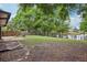 Lush backyard featuring mature trees, a pond, and fenced perimeter for privacy at 1010 Elm Grove Ln, Valrico, FL 33596