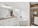 Bright bathroom featuring a garden tub and tiled shower at 1010 Elm Grove Ln, Valrico, FL 33596