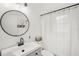 Stylish bathroom featuring modern fixtures, clean lines, and a round mirror at 1010 Elm Grove Ln, Valrico, FL 33596
