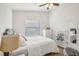Bright bedroom featuring a large window and light hardwood floors at 1010 Elm Grove Ln, Valrico, FL 33596