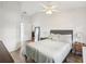 Bright bedroom featuring a large bed and wood flooring at 1010 Elm Grove Ln, Valrico, FL 33596
