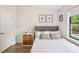 Inviting bedroom featuring a comfortable bed, stylish decor, and a window at 1010 Elm Grove Ln, Valrico, FL 33596