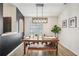 Well-lit dining room featuring a wooden table, bench seating and stylish light fixture at 1010 Elm Grove Ln, Valrico, FL 33596