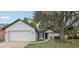 Charming single-story home with a well-maintained lawn and mature shade tree at 1010 Elm Grove Ln, Valrico, FL 33596