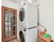 Functional laundry room with a stacked washer and dryer and convenient storage at 1010 Elm Grove Ln, Valrico, FL 33596
