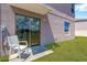 Back patio featuring a glass sliding door, concrete paver, and small seating area at 10142 Golden Wonder Ln, Riverview, FL 33578