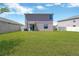 Spacious backyard with lush green lawn and privacy fence, perfect for outdoor activities at 10142 Golden Wonder Ln, Riverview, FL 33578