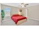 Bright bedroom with a large window, ceiling fan, and neutral colored walls at 10142 Golden Wonder Ln, Riverview, FL 33578