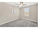 Neutral bedroom showcasing gray carpet and a window with blinds for natural light at 10142 Golden Wonder Ln, Riverview, FL 33578