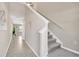 Bright hallway with tile flooring, a staircase, and views into the dining area offering an open layout at 10142 Golden Wonder Ln, Riverview, FL 33578