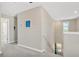 Upstairs hallway with gray carpet leading to bedrooms and a window with natural light at 10142 Golden Wonder Ln, Riverview, FL 33578
