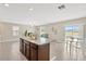 Bright and airy kitchen seamlessly blending into the living room and dining area with ample natural light at 10142 Golden Wonder Ln, Riverview, FL 33578