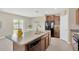 Modern kitchen featuring granite countertops, stainless steel appliances, and an island for extra prep space at 10142 Golden Wonder Ln, Riverview, FL 33578