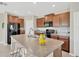 Well-equipped kitchen island with seating, granite countertops, and stainless steel appliances for convenience at 10142 Golden Wonder Ln, Riverview, FL 33578