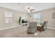 Well-lit living room with tile floors and neutral paint; complete with ceiling fan at 10142 Golden Wonder Ln, Riverview, FL 33578