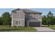 Charming two-story home with a two-car garage, complemented by a well-manicured lawn and landscaping at 10319 Gentle Rain Dr, Land O Lakes, FL 34638