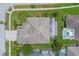 Aerial view of a single-Gathering home featuring a screened pool, well-maintained landscaping, and a traditional roof at 10502 Brentford Dr, Tampa, FL 33626