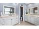 Elegant bathroom featuring double vanities, modern fixtures, and separate toilet room for added privacy at 10502 Brentford Dr, Tampa, FL 33626