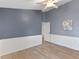 Bedroom featuring neutral walls, modern trim, and wood-look flooring at 10502 Brentford Dr, Tampa, FL 33626