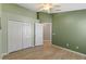 Bright bedroom featuring wood floors, large closet, and a neutral color scheme at 10502 Brentford Dr, Tampa, FL 33626