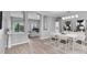 Open concept dining room with modern lighting, flowing into the living area, great for entertaining at 10502 Brentford Dr, Tampa, FL 33626
