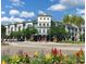 Exterior view of a mixed-use commercial building with a retail storefront and colorful flowerbeds at 10502 Brentford Dr, Tampa, FL 33626