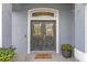 Elegant double front doors with decorative glass and transom window, creating a welcoming entrance at 10502 Brentford Dr, Tampa, FL 33626