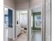 Hallway with doorways to a blue bedroom, bathroom, and green bedroom at 10502 Brentford Dr, Tampa, FL 33626