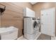 Neat laundry room with modern washer and dryer, sink, and overhead cabinets for ample storage at 10502 Brentford Dr, Tampa, FL 33626