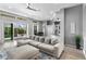 Bright living room featuring an oversized sectional sofa and seamless access to the outdoor patio at 10502 Brentford Dr, Tampa, FL 33626