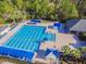 Aerial view of a large community pool and sun deck with ample lounge seating and shade structures at 10502 Brentford Dr, Tampa, FL 33626