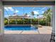 Screened-in pool and patio area with lush landscaping and an inviting spa at 10502 Brentford Dr, Tampa, FL 33626