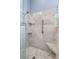 Close up of tiled shower with herringbone floor, corner seat, and sleek shower fixtures at 10502 Brentford Dr, Tampa, FL 33626