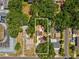 An aerial view showcasing the property, with the white border emphasizing its location amidst lush greenery at 106 W Louisiana Ave, Tampa, FL 33603