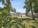 Expansive backyard featuring mature trees, outdoor seating and a detached garage at 106 W Louisiana Ave, Tampa, FL 33603