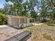 Spacious backyard with detached garage, covered patio, and outdoor seating at 106 W Louisiana Ave, Tampa, FL 33603