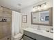 Bathroom featuring a shower with tile surround, updated vanity and modern fixtures at 106 W Louisiana Ave, Tampa, FL 33603