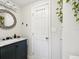 Bathroom with modern vanity, rustic mirror, and decorative accents at 106 W Louisiana Ave, Tampa, FL 33603